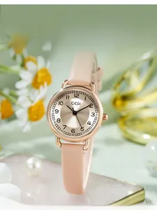 Detail of rose gold quartz watch with pink leather strap on elegant silk background