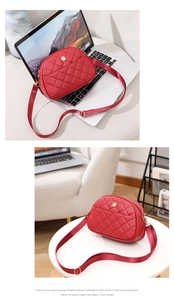 Close-up of red quilted messenger bag with golden flower clasp and adjustable strap