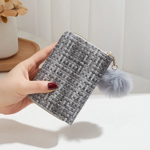 Mini woven coin purse in grey and white with a soft plush ball keychain charm