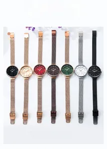 Collection of seven minimalist women's watches with metallic mesh straps in various colors
