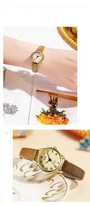Détail de montre quartz vintage GEDI avec cadran romain doré et bracelet en cuir brun
