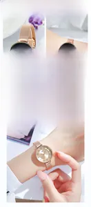 Detailed view of women's fashion watch with rose gold mesh strap and minimalist dial