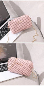 Close-up of pink embroidered chain bag with geometric circular patterns and gold hardware