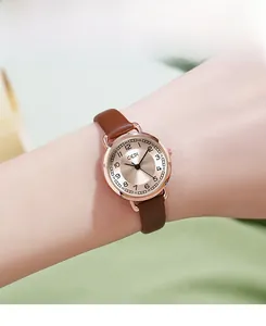 Close-up of a women's vintage quartz watch with a brown leather strap and rose gold case