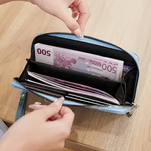 Light blue faux leather zip-around wallet featuring a spacious interior with multiple card slots