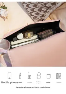 Pink quilted shoulder bag showing interior storage for phone, perfume and essentials