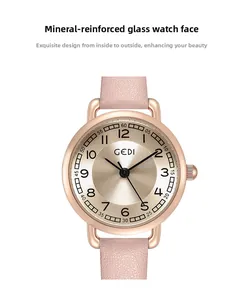 Close-up of mineral glass lens and rose gold dial with leather strap of woman watch