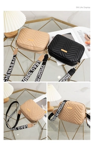 Detail of quilted leather crossbody bags with metal plates and wide letter straps