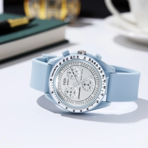 Macro shot of light blue quartz chronograph with tachymeter and silicone strap on desk