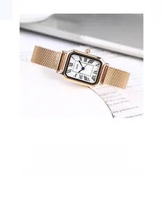 Detail of GEDI rose gold mesh strap watch with vintage rectangular dial and roman numerals