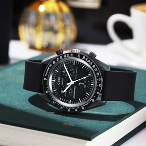 Detailed close-up of a black quartz chronograph watch with matte silicone strap on a book