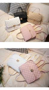 Detail of diamond quilted backpack with gold turn-lock closure and leather top handle