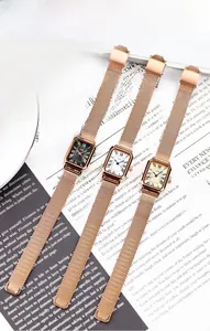 Detailed shot of retro rectangular quartz watches with Roman dials and Milanese mesh straps