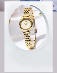 Detailed view of women's vintage octagonal quartz watch with a golden steel mesh strap
