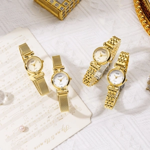 Collection of GEDI gold quartz watches with mesh and link bands on a music sheet