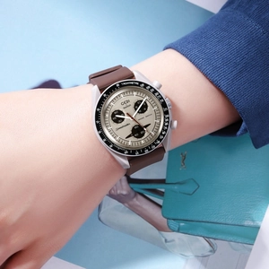 Detailed view of fashionable quartz sports watch with cream dial and brown rubber strap