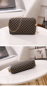 Macro view of vintage brown crossbody bag with gold chain strap and circle pattern details