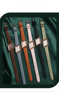 Flat lay of vintage square quartz watches with leather straps in six assorted colors