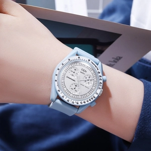 Detail of light blue quartz chronograph watch with silicone strap on a female wrist