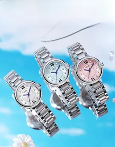 Three luxury GEDI silver steel watches with white, blue, and pink dials on a sky background