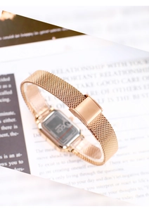 Detailed macro view of the rose gold Milanese mesh strap and square watch case back