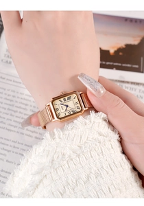 Close-up of GEDI vintage square watch with rose gold mesh strap on a female wrist