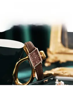 Detail of rhombic vintage watch dial with rose gold case and brown leather strap