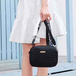 Classic black quilted camera bag with V-shaped wave pattern and woven shoulder strap