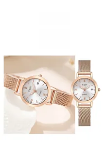Detail view of rose gold mesh band quartz watch with crystal indices and date display