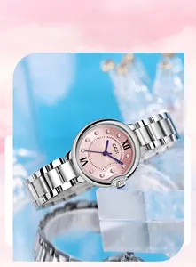 Close-up of pink sunray dial with Roman numerals and blue hands on a steel watch