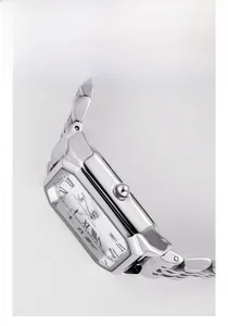 Detail of silver rectangular steel watch case with Roman numeral dial and link strap