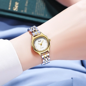 Close-up of Gedi quartz watch with silver and gold metal strap on a woman's wrist