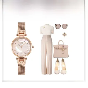 Macro detail of rose gold mesh strap watch with mother-of-pearl dial for women