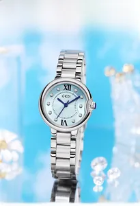 Close-up of a silver steel watch with a light blue sunray dial and rhinestone markers