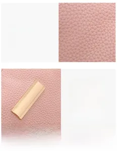 Detail of pink lychee textured leather and rectangular gold metal hardware on shoulder bag
