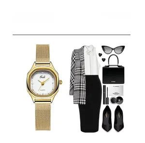 Detailed view of Gedi gold mesh watch paired with a professional business outfit set