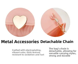Detail of pink bag featuring a gold heart-shaped metal lock and detachable chain strap