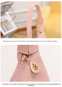 Detail of pink shoulder bag showing lychee grain leather texture and gold leaf zipper