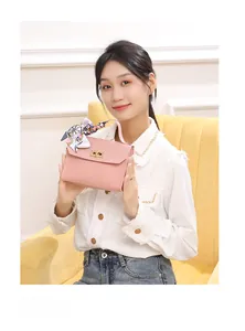 Pink quilted leather handbag detail with silk scarf handle and metal twist lock
