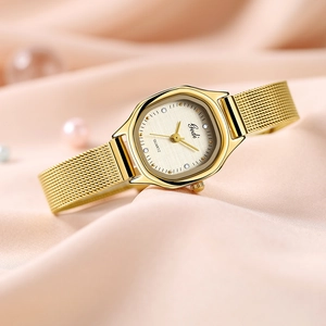 Elegant gold quartz watch for women with mesh band and textured dial on silk background