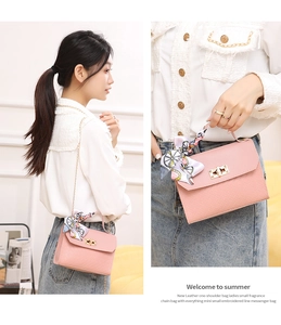 Detail of pink quilted leather bag featuring floral scarf handle and gold square lock