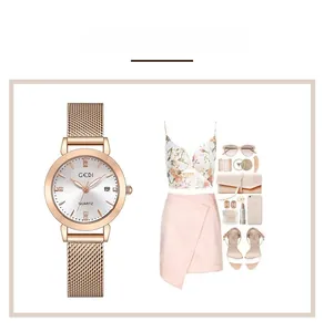Detail of rose gold mesh strap watch with crystal markers and date display