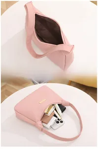 Internal storage view of pink lychee pattern hobo bag showing daily essentials