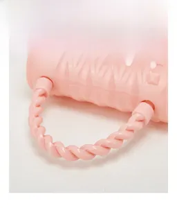 Detail of pink jelly bag featuring a braided handle and embossed square stud texture