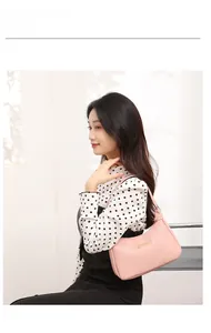 Pink lychee grain shoulder bag featuring a sleek rectangular gold metal plate detail