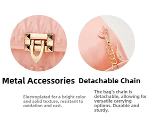 Detail of pink jelly bag showing gold hardware lock with rivets and detachable chain