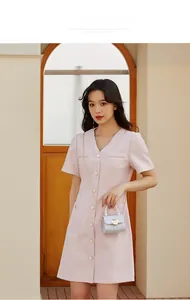 Pink short sleeve tweed dress styled with a white mini heart lock chain bag for women