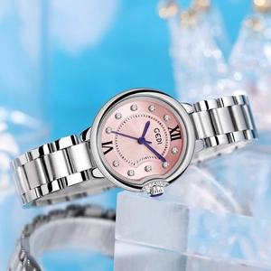 GEDI luxury women's watch with pink textured dial and silver steel band on blue background