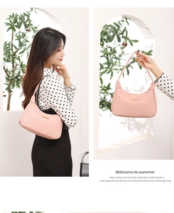 Pink lychee texture shoulder bag with gold hardware shown on a model for size reference