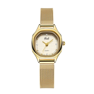 Detail of gold quartz watch with a textured dial and mesh stainless steel strap